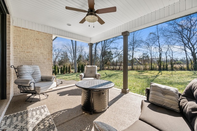 view of patio / terrace with ceiling fan and an outdoor fire pit