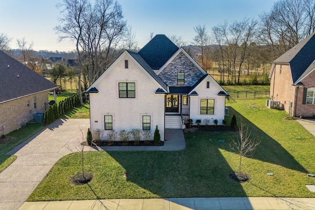 view of front of house featuring a front yard and central air condition unit