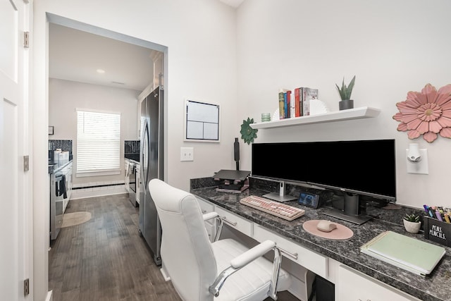 office area featuring dark hardwood / wood-style flooring and built in desk