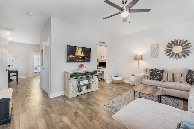 living room with hardwood / wood-style flooring and ceiling fan