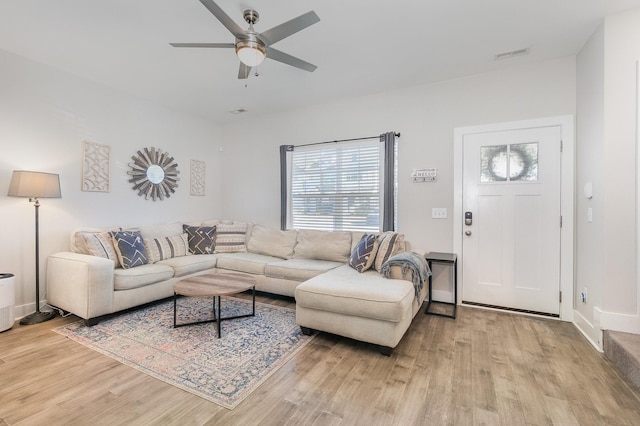 living room with light wood-type flooring and ceiling fan