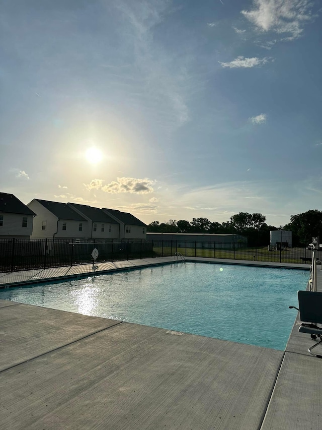 pool at dusk with a patio