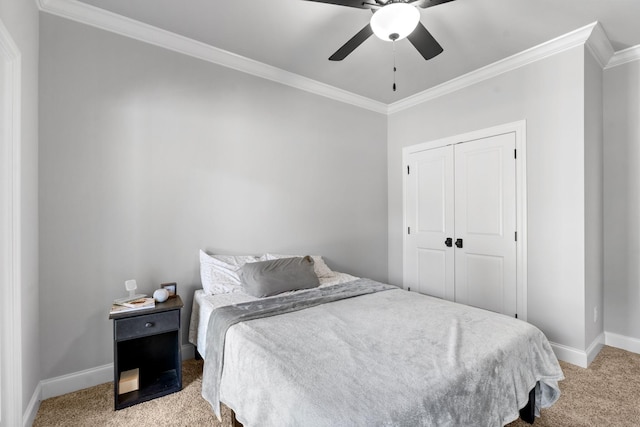 bedroom featuring a closet, ceiling fan, light colored carpet, and crown molding