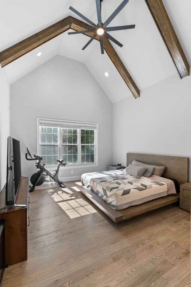 bedroom featuring ceiling fan, light hardwood / wood-style floors, and lofted ceiling