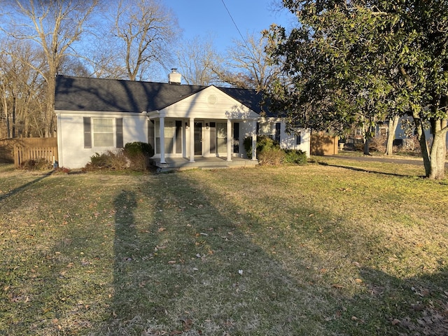 view of front of home with a front yard and covered porch