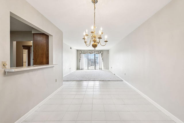 hallway with an inviting chandelier and light tile patterned floors