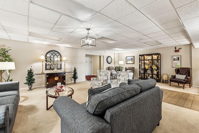 living room featuring a paneled ceiling and light colored carpet