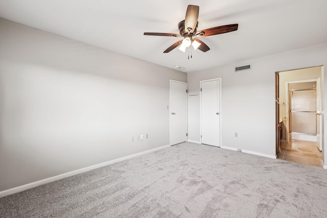 unfurnished bedroom with light colored carpet and ceiling fan