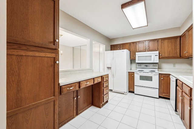 kitchen with white appliances and light tile patterned floors