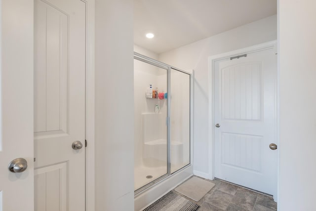 bathroom with a shower with door