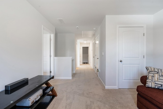 hall featuring light colored carpet