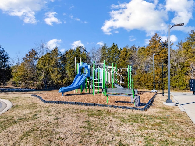 view of playground with a lawn