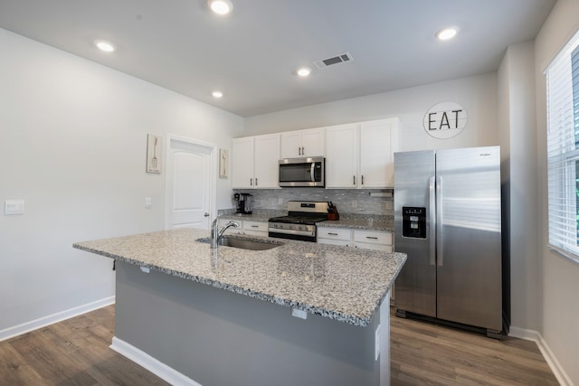 kitchen featuring white cabinetry, stainless steel appliances, an island with sink, sink, and dark hardwood / wood-style floors