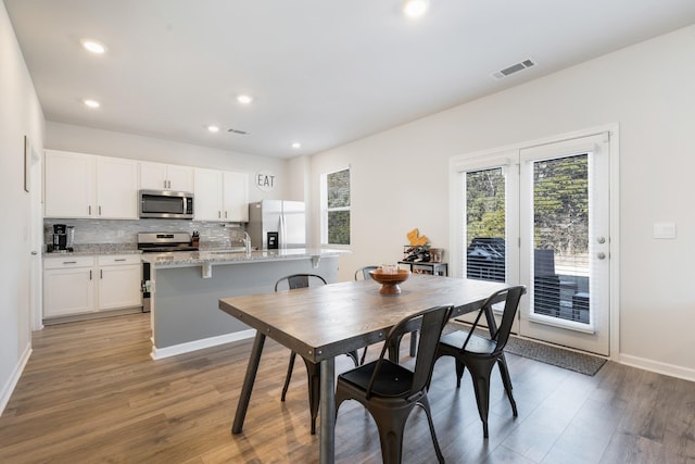 dining area featuring wood-type flooring