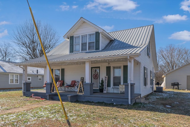 view of front of house with covered porch, central AC unit, and a front lawn