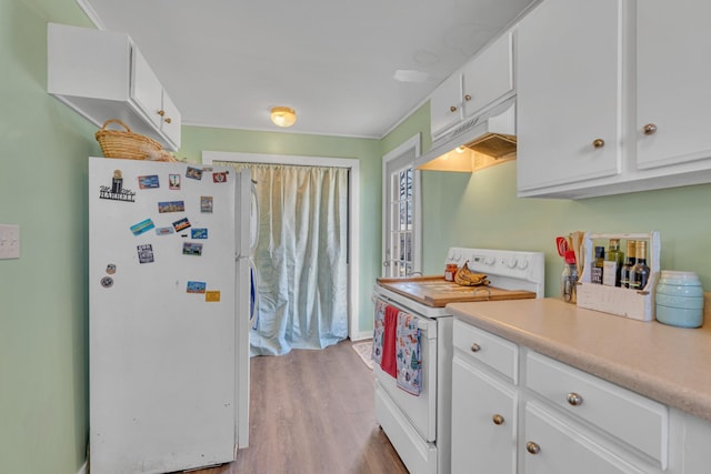 kitchen with white appliances, white cabinets, and light hardwood / wood-style floors