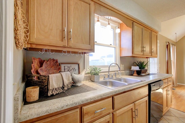 kitchen with light tile patterned flooring, light brown cabinetry, dishwasher, and sink