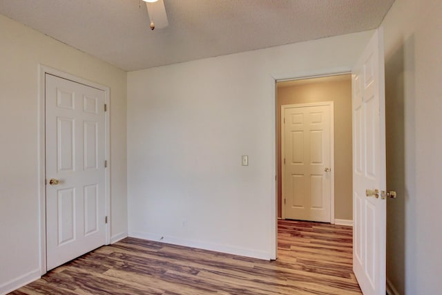 empty room featuring hardwood / wood-style flooring and a textured ceiling