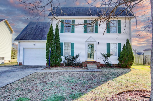 view of front of home featuring a garage and a yard