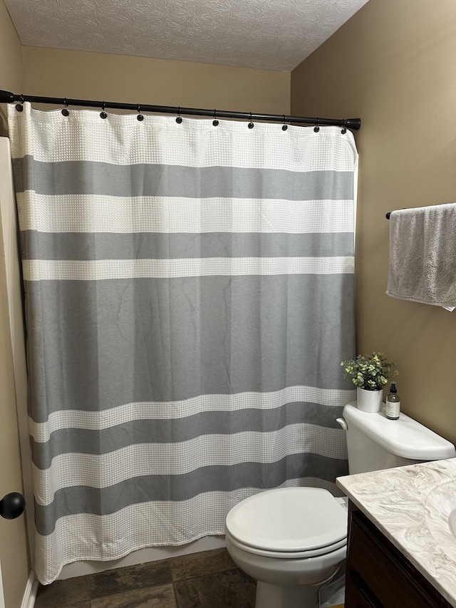 bathroom with a textured ceiling, toilet, vanity, and hardwood / wood-style floors