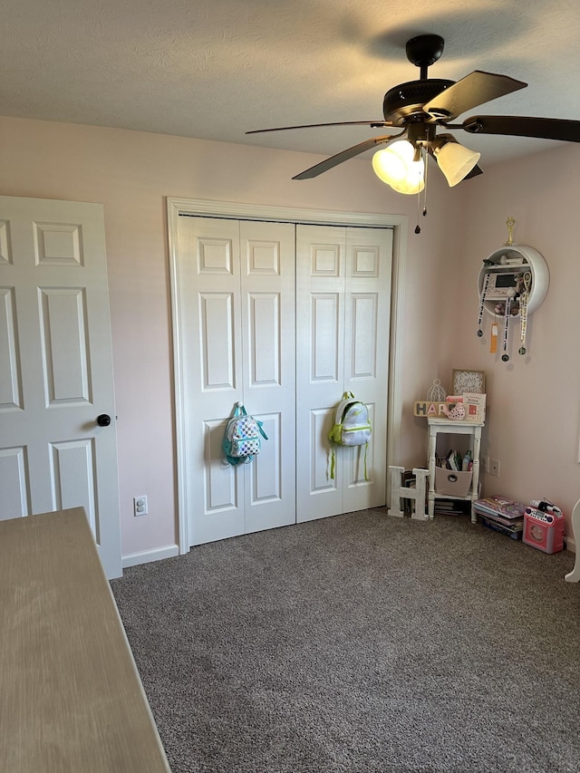 unfurnished bedroom with a closet, ceiling fan, and carpet