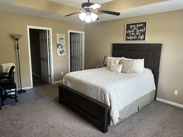 carpeted bedroom featuring ceiling fan and a textured ceiling