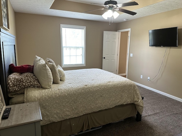 carpeted bedroom with ceiling fan and a textured ceiling