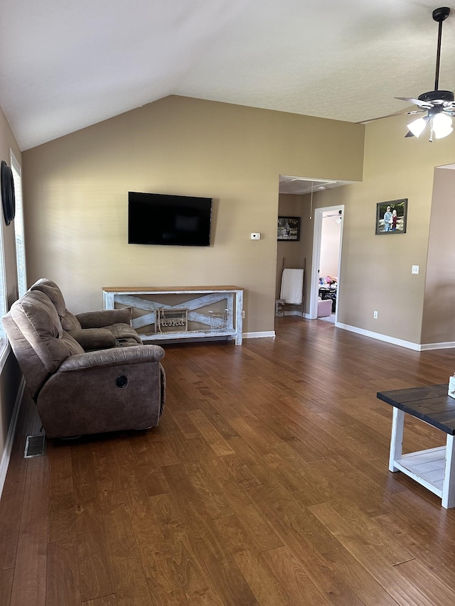 living room featuring vaulted ceiling, ceiling fan, and dark hardwood / wood-style flooring