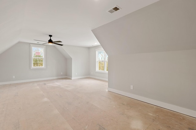 bonus room featuring ceiling fan, a healthy amount of sunlight, and lofted ceiling