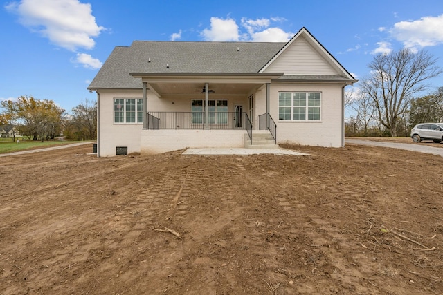 rear view of house featuring ceiling fan and a porch