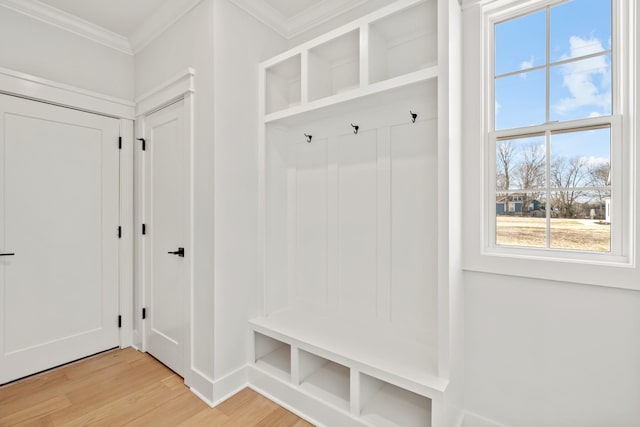 mudroom with light wood-type flooring and ornamental molding