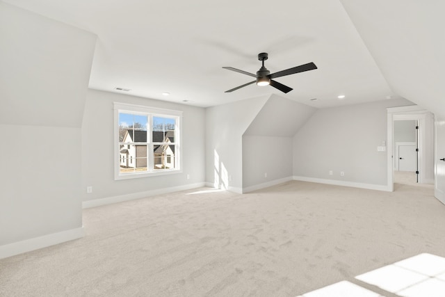 bonus room with light colored carpet, lofted ceiling, visible vents, and baseboards