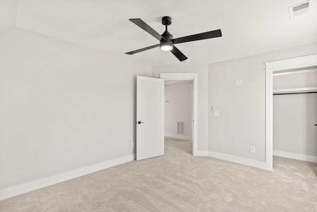 unfurnished bedroom featuring a closet, visible vents, light carpet, and baseboards