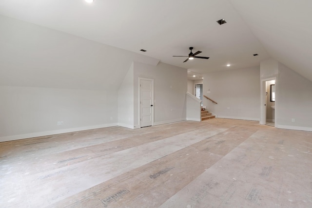 unfurnished living room featuring ceiling fan and vaulted ceiling