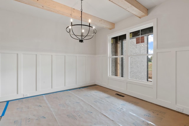 unfurnished dining area featuring beamed ceiling and a notable chandelier