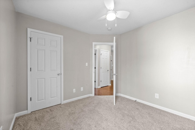 unfurnished bedroom with carpet flooring and ceiling fan