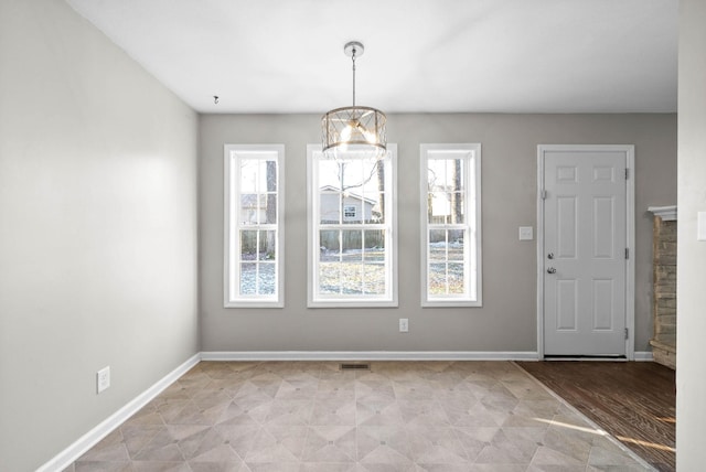 unfurnished dining area with a chandelier