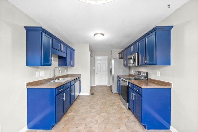 kitchen with stainless steel appliances, sink, and blue cabinets