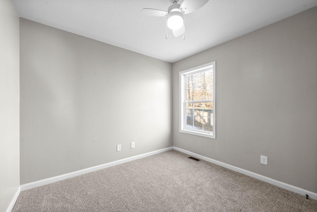 spare room featuring ceiling fan and carpet