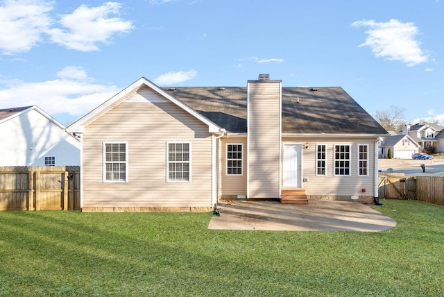 rear view of house featuring a yard and a patio area