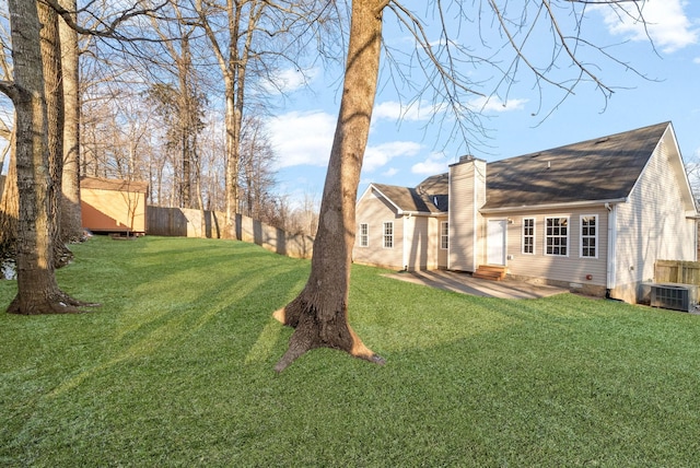 view of yard featuring a storage unit and a patio area