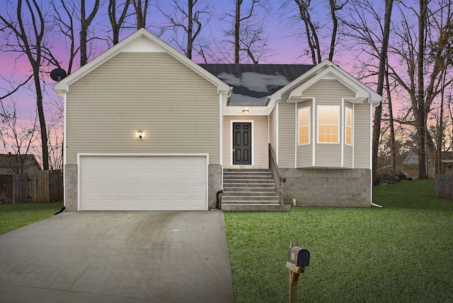 view of front of house featuring a garage and a yard