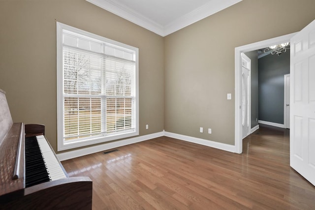 unfurnished room with wood-type flooring and crown molding