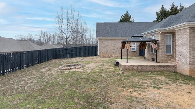 view of yard featuring a fire pit, a gazebo, and a patio