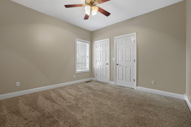 unfurnished bedroom with ceiling fan and carpet