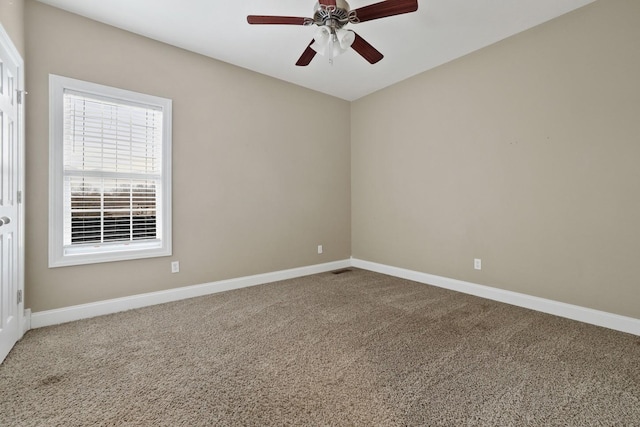 empty room featuring ceiling fan and carpet flooring