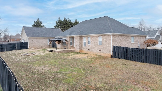 back of house featuring a gazebo, a lawn, and a patio