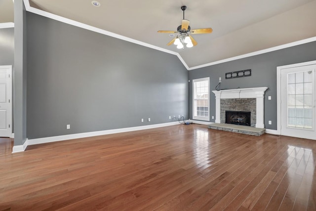 unfurnished living room with vaulted ceiling, ceiling fan, a fireplace, hardwood / wood-style floors, and ornamental molding