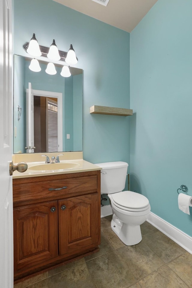 bathroom with toilet and vanity