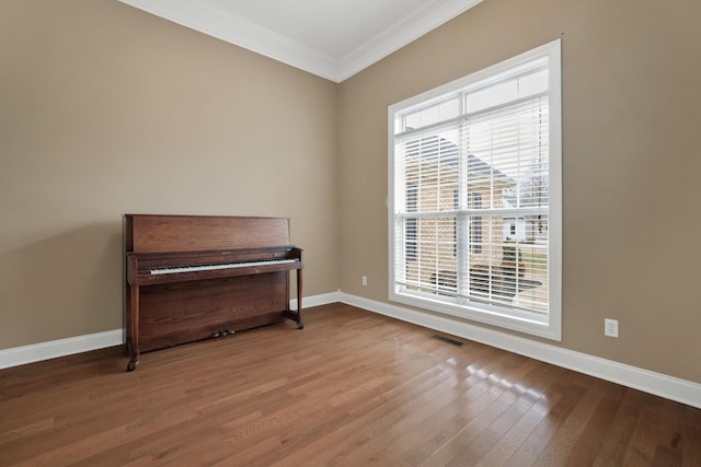 unfurnished room with crown molding and wood-type flooring